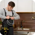 Plumber smiling while preparing tools